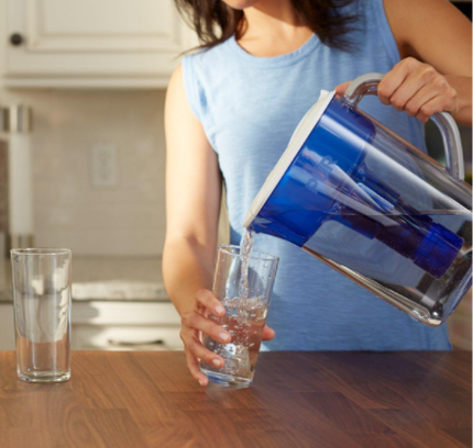 woman pouring water filtered and unfiltered water comes out when pour